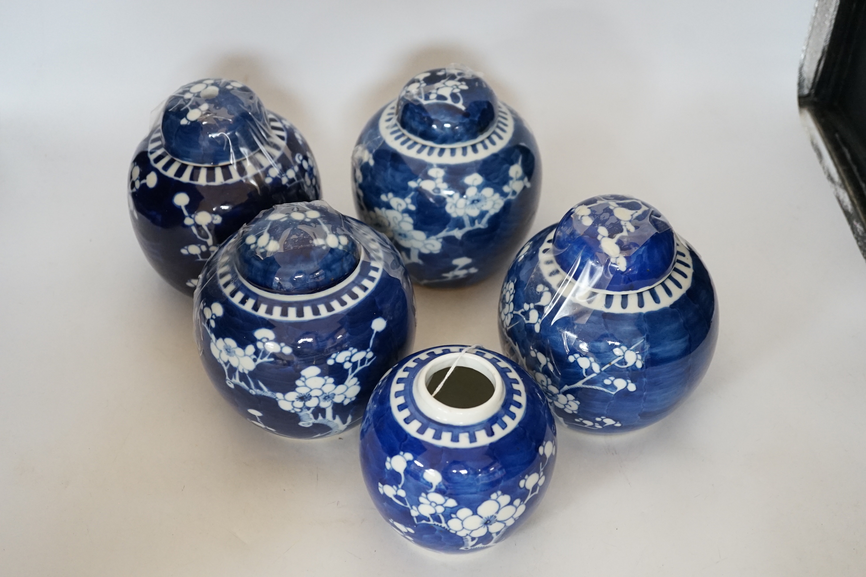 Five Chinese blue and white prunus jars and covers